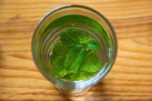 Glass of water with mint Add fresh mint leaves to your water for a refreshing twist.